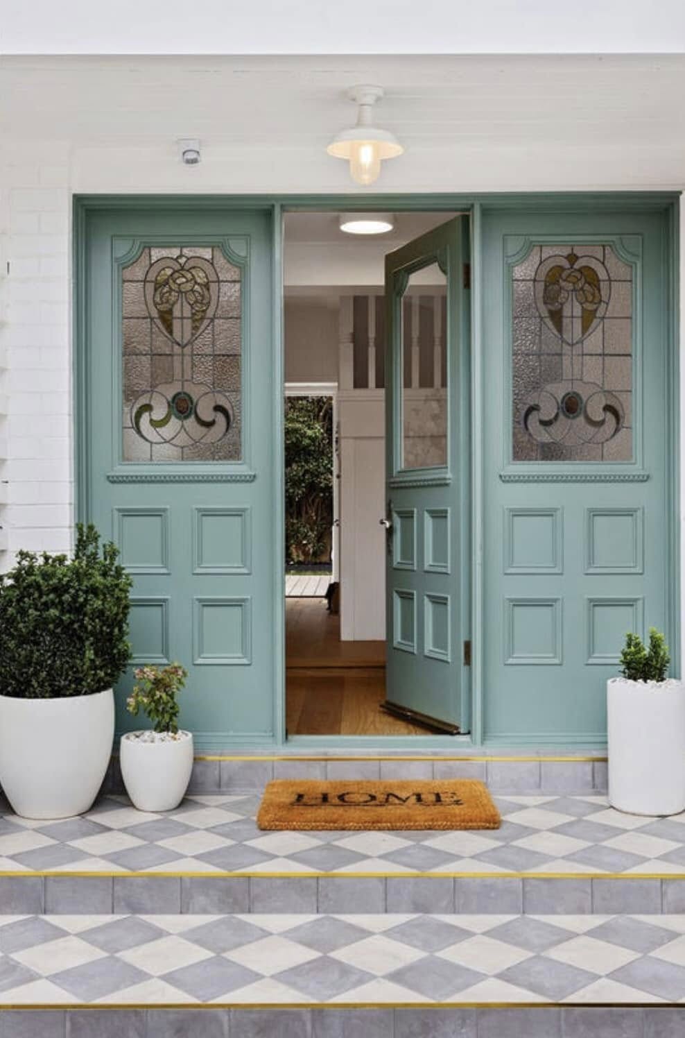 Weathered timber entry and dark brickwork transformed with a soft duck-egg door and clean white surrounds. — after